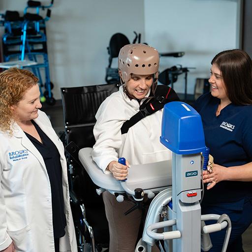 Dr. Shapiro and a staff member work on a rehabilitation exercise with a patient.
