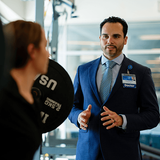 Physician guiding patient through exercise.