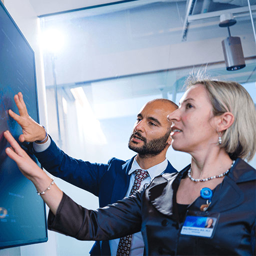 Physicians reviewing graph on screen