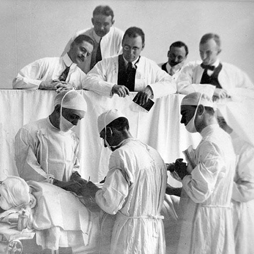 Historical photo of visiting surgeons observing at Mayo Clinic