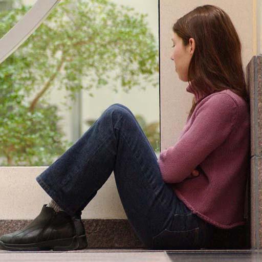 Student sitting alone looking out the window