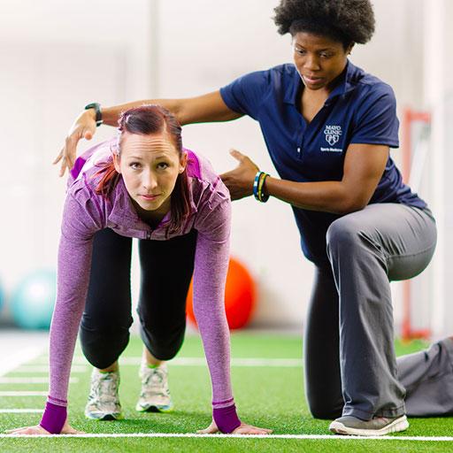 Mayo Clinic athletic trainer working with a sprinter
