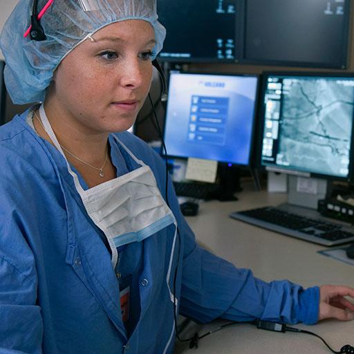 Mayo Clinic cardiovascular invasive specialist reviewing imaging scans on a computer
