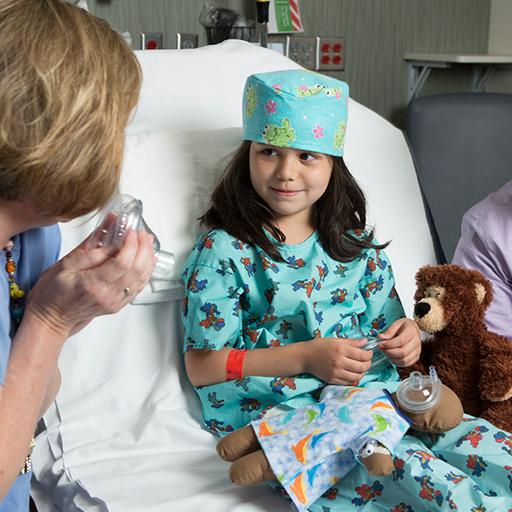 Mayo Clinic child life specialist playing with toys with a child