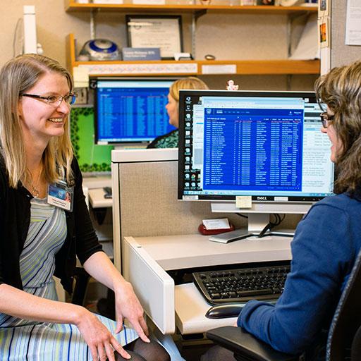 Mayo Clinic health information managers sitting by a computer