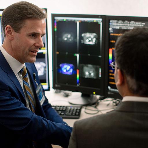 Mayo Clinic positron emission tomography (PET) technologists discussing results