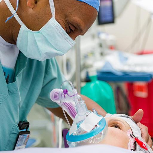 Surgeon speaking with a young patient in the OR