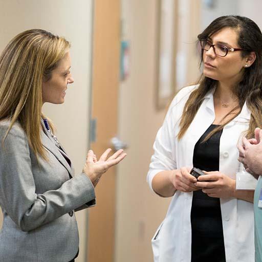 Three physicians collaborating in the hallway at Mayo Clinic
