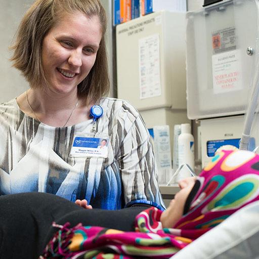 Nurse midwife examines a pregnant mother in a Mayo Clinic exam room