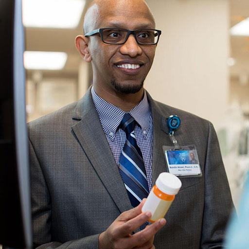 Pharmacist speaks with a patient about medication