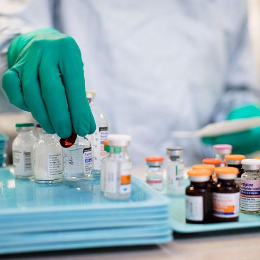 Pharmacy technician in training sorting through medications in a lab
