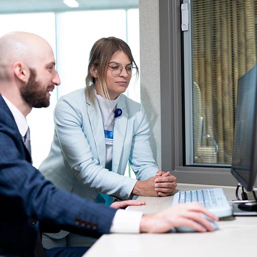 Two pharmacy residents looking at computer