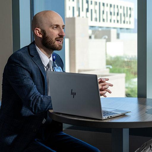 Residents in the Solid Organ Transplant Pharmacy Residency at Mayo Clinic in Arizona discuss orders on a computer.