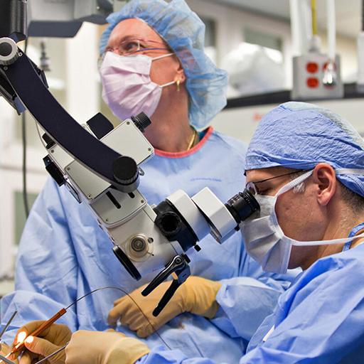 Surgeons in the OR working on transoral approaches in head and neck surgery.