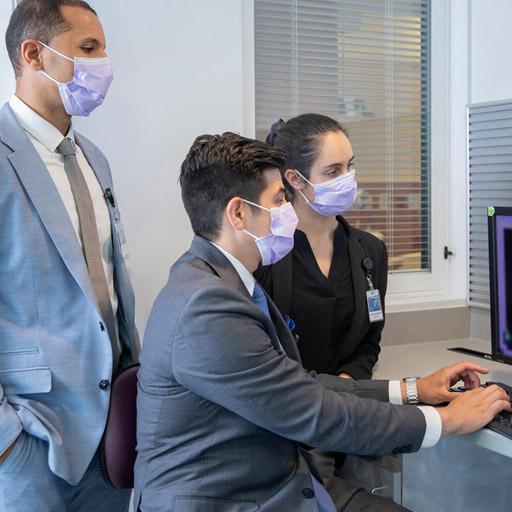 Advanced Endoscopy Fellowship fellows at Mayo Clinic in Jacksonville, Florida having a discussion and looking at a computer monitor.