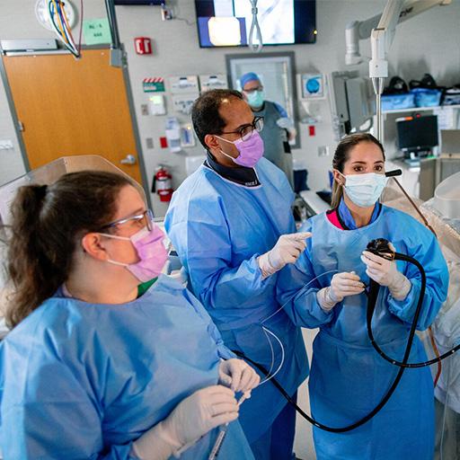 Mayo Clinic Advanced Endoscopy Fellowship trainee focuses on fluoroscopic images and prepare to inject contrast during endoscopic retrograde cholangiopancreatography (ERCP) in the operating room.