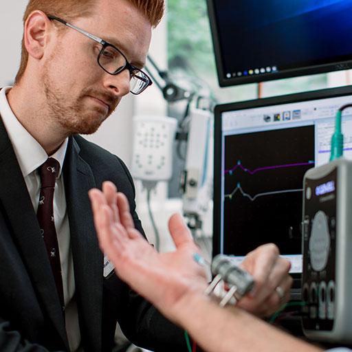 Fellow and patient working in the autoimmune neurology lab