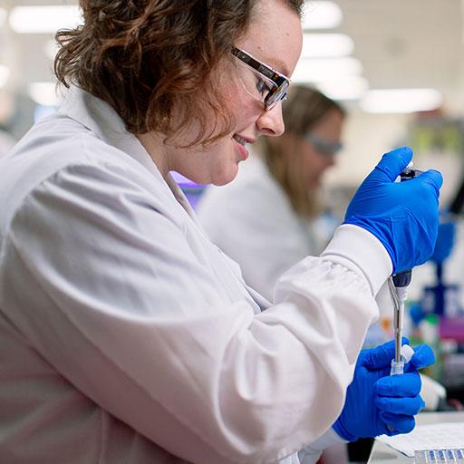 Clinical microbiology fellow pipetting in the lab