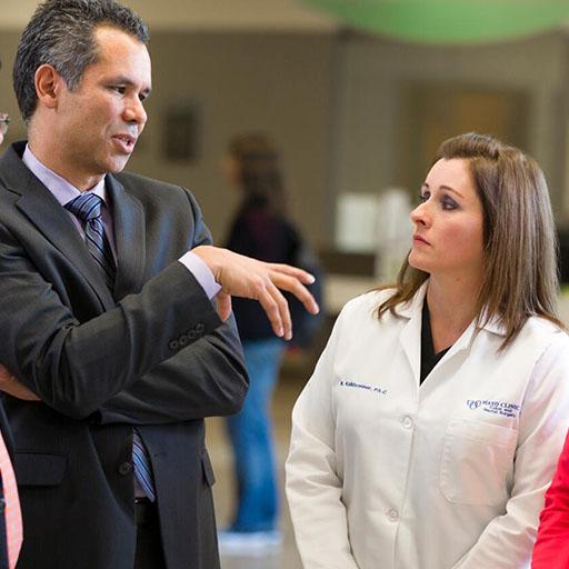 Colon and rectal surgery fellows and faculty talking about a case in the hallway at Mayo Clinic