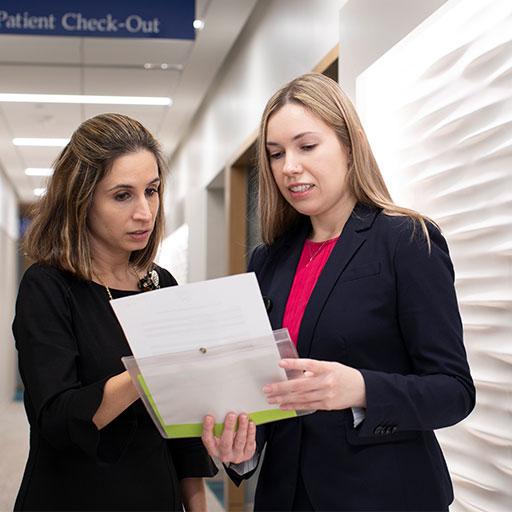 Dermatology faculty talking in a hallway