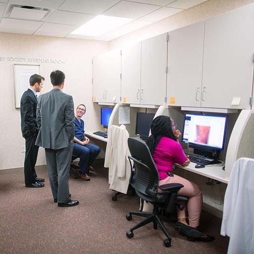 Dermatology residents in the Resident Room on the 16th floor of the Gonda building