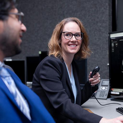 A faculty member and resident from the Diagnostic Radiology Residency program in Rochester, Minnesota, sat at a desk reviewing information on two computer monitors.