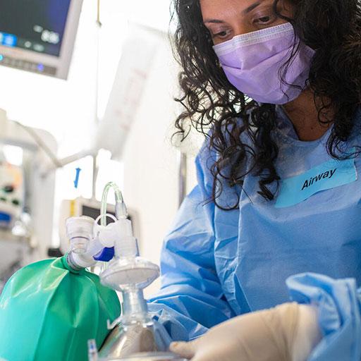 Emergency medicine resident practices assisting a patient's airway