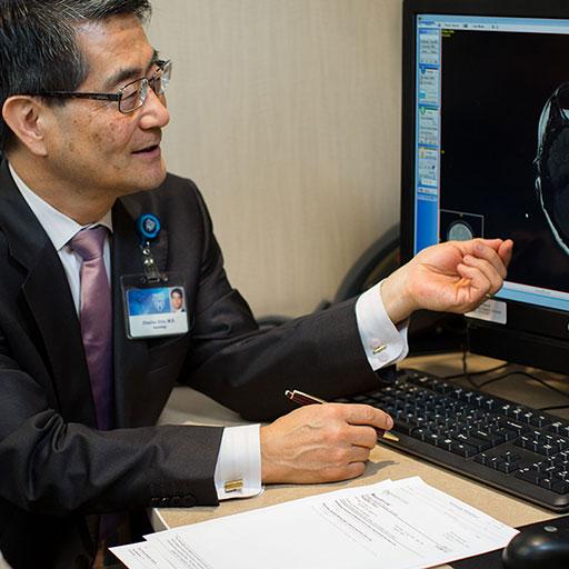 Physician examining an image while consulting with a patient