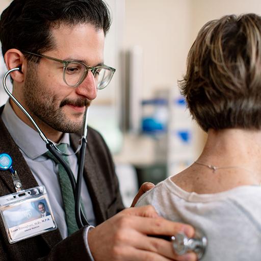 Geriatric physician talks with patient