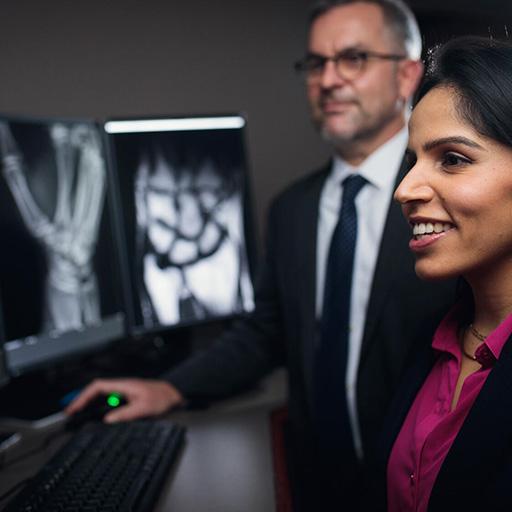 Two doctors from the Musculoskeletal Imaging Fellowship program in Rochester, Minnesota, review images at a computer station.