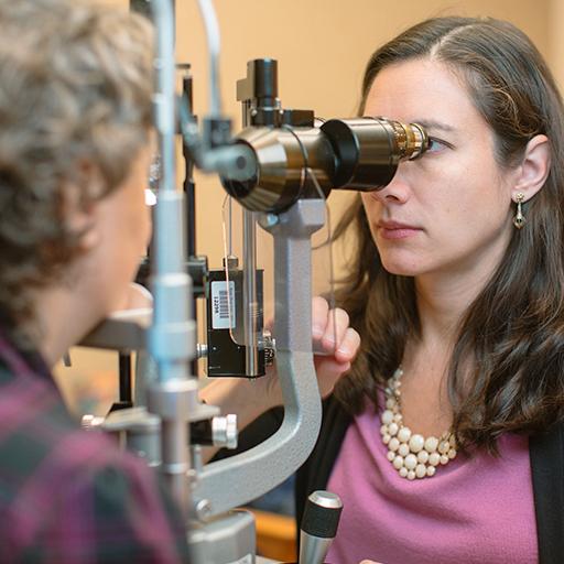 Oculoplastic and orbital surgery fellow works with a patient.