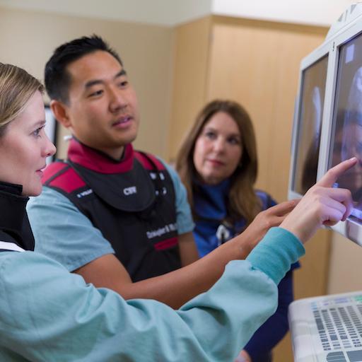 Pain medicine fellows study an image in the clinic