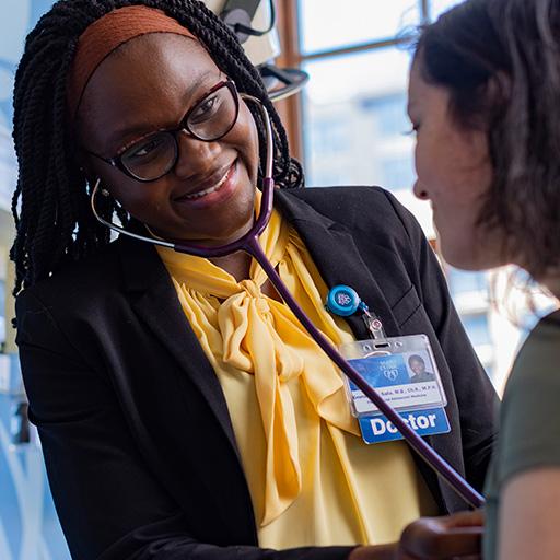 Doctor examining patient with a stethoscope