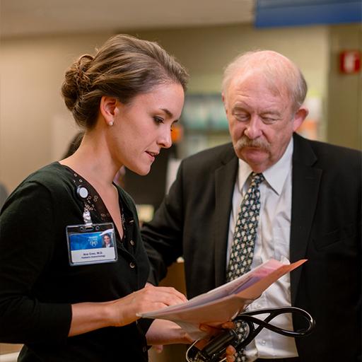 Fellow Ana Creo, M.D., consults with Dr. Schwenk