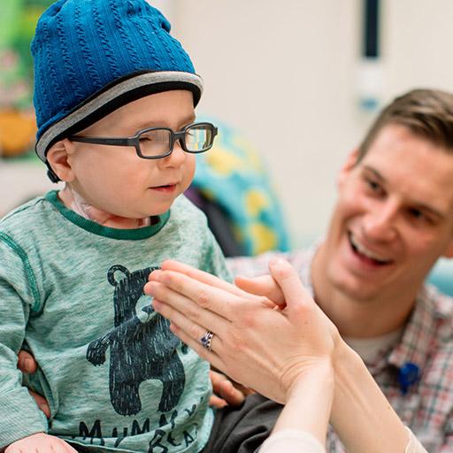 A Mayo Clinic pediatric surgeon examining a young patient