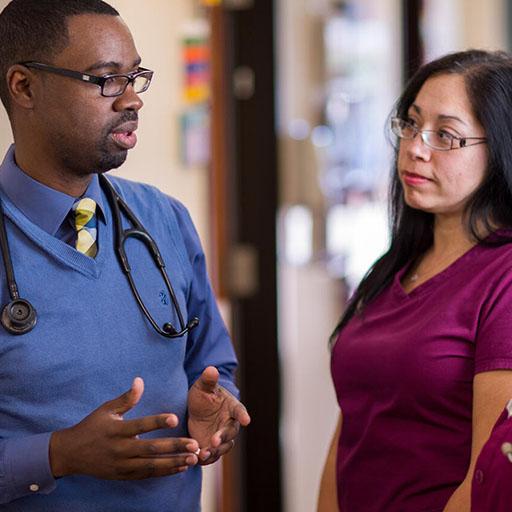 Mayo Clinic preventive medicine physician talking in hallway with two nurses