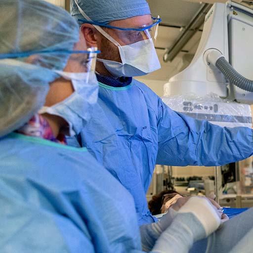 Radiologists perform a procedure in the operating room