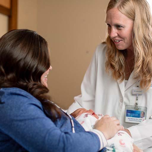 Mayo Clinic obstetrician in hospital with mother and newborn