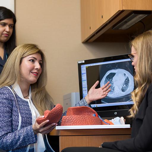 Pulmonary Critical Care resident speaks with a patient.