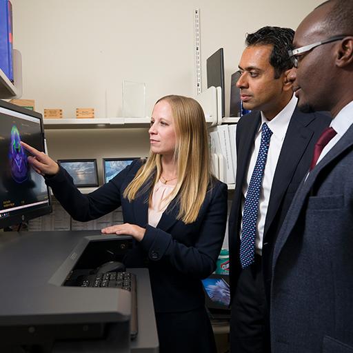 Radiation oncologist residents look at a scan.