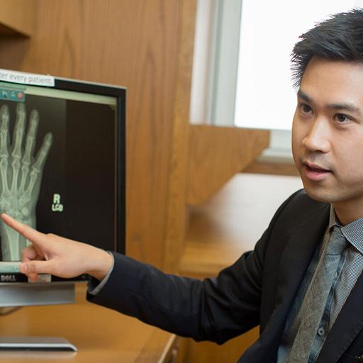 A fellow in the Rheumatology Fellowship at Mayo Clinic in Phoenix, Arizona, speaks with a patient in a clinical office.