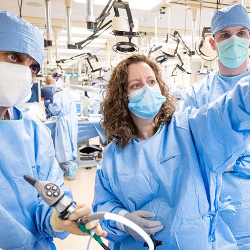 Three fellows from rhinology and skull base surgery fellowship in surgical suite