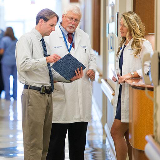 Liver transplant team collaborating in the hallway