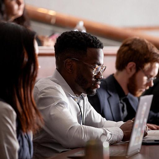 Medical students sit in a lecture hall looking at laptop computer screens during class at Mayo Clinic Alix School of Medicine.