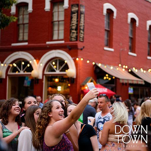 Residents taking photos at Thursdays on First & Third festival