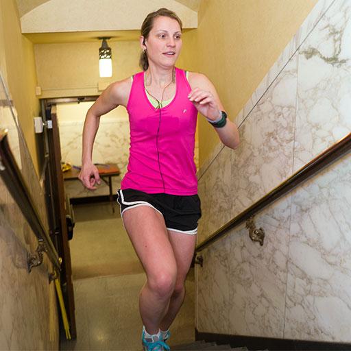Student at Mayo Clinic racing up a flight of stairs as part of Climb the Clinic
