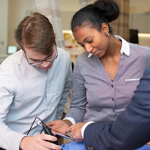 Physician assistants (PA) use a transducer to perform an ultrasound on a patient's abdomen.