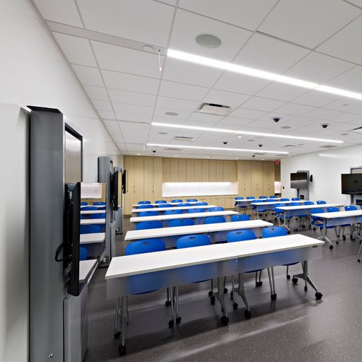 The classroom at the Center for Procedural Innovation on the Mayo Clinic Scottsdale campus, with seating for up to 48 people and 7 wall-mounted monitors.
