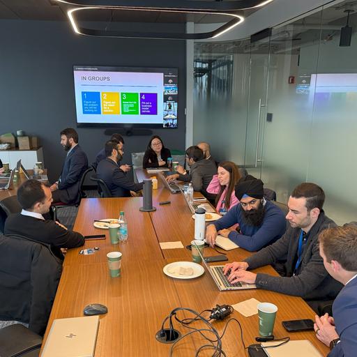 Trainees sit around a large conference table