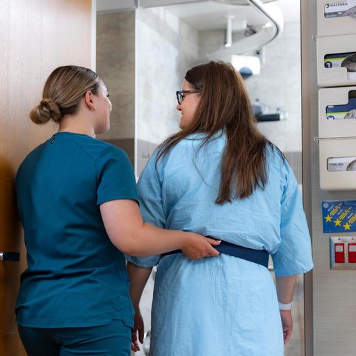A doctor walking with a patient.